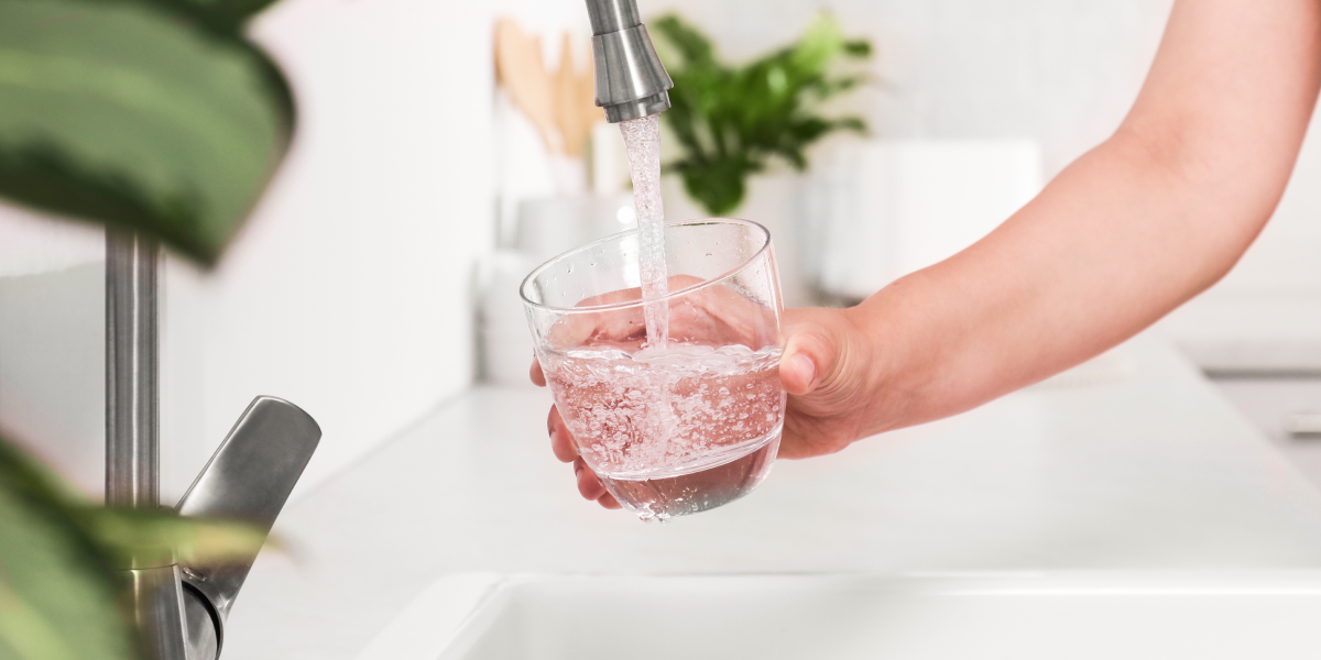 clean water pours out of a kitchen sink faucet